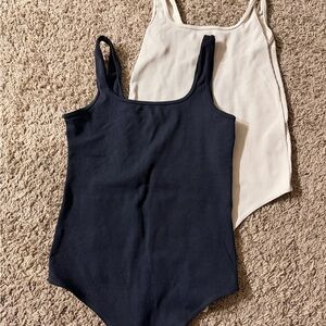 Black and cream women’s bodysuits